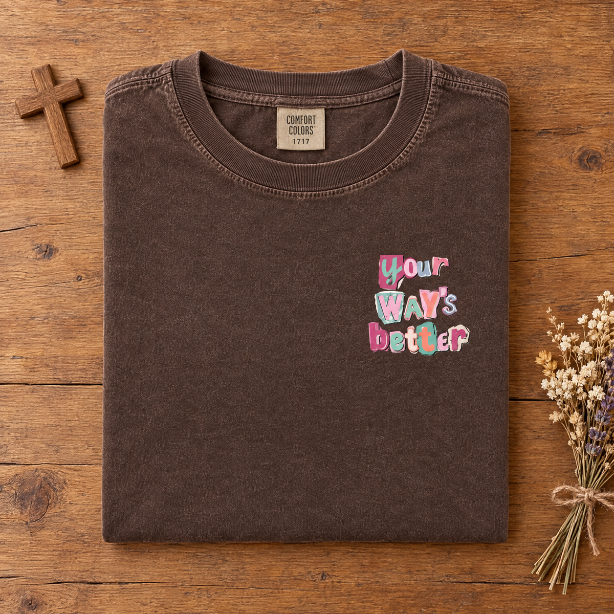 Christian faith tee in Espresso, folded with a small wooden cross and dried flowers