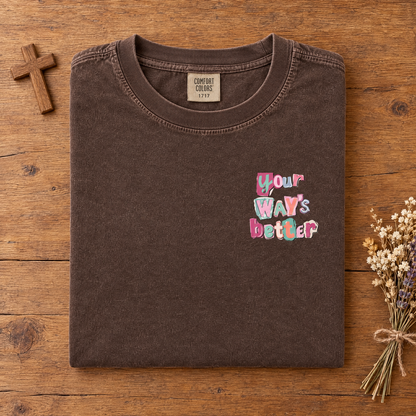 Christian faith tee in Espresso, folded with a small wooden cross and dried flowers